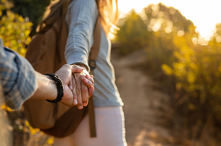 Hiking couple holding hands, a Person Photo by Jacob Lund