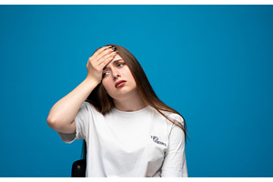 Young woman suffering from headache, a Person Photo by volodymyrshtun13795