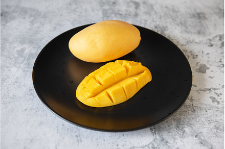 Fresh yellow mango fruit in a black, a Food & Drink Photo by Jan Jack Russo Media