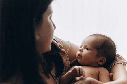 Happy Mothers day! Stylish Mother holding and hugging cute newbo
