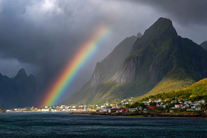 Colorful rainbow over a coastal town, a Photo by Beautiful things