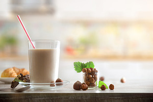 Background with glass with hazelnut drink and nuts in kitchen, a Food & Drink Photo by Davizro's Market