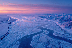 Aerial view of a frozen river windin, a Photo by Pixeness Studio
