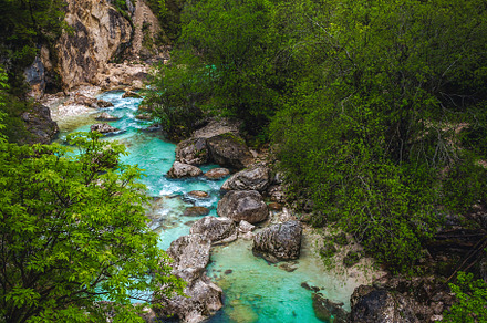 Soca river with rocky shoreline, a Nature Photo by Alpine Dreams