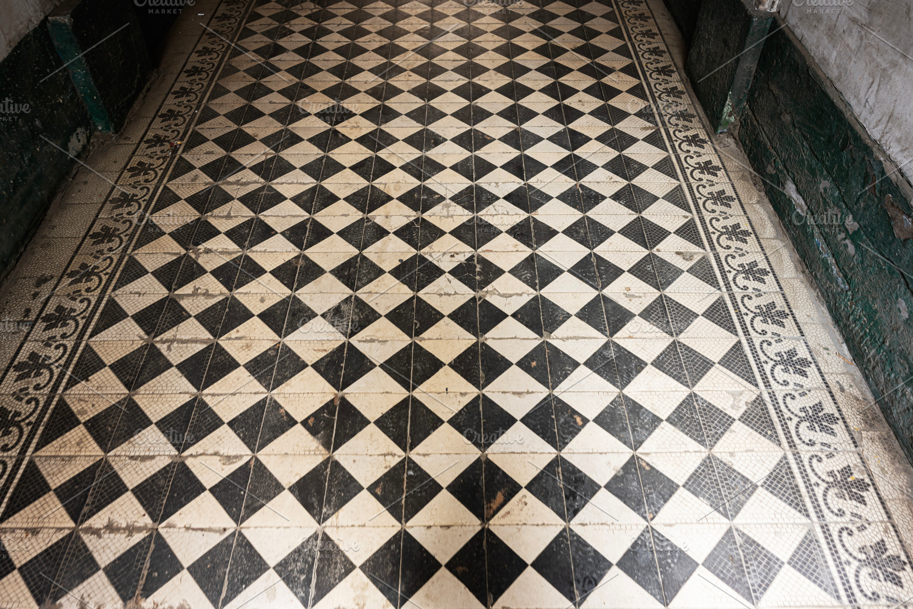 Checkerboard tiled hallway with intricate border and aged vintage appeal, a Photo by AS photostudio