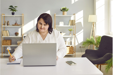 Woman studying online, sitting at, a Technology Photo by StudioRomantic