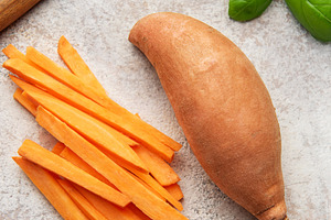 Preparing raw sweet potatoes for healthy fries with basil, a Food & Drink Photo by Olena Rudo