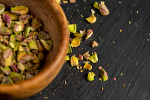pistachios chopped and crushed into pieces of different sizes, a bunch of crunc, a Photo by rsoollAI