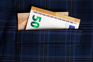 Fifty euro banknote peeking out of a blue plaid shirt pocket, symbolizing savin, a Business Photo by Ales Munt