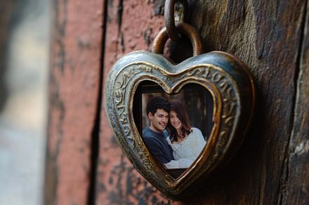 Heart-shaped locket hangs on wooden, a Photo by Tanuart