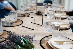 Elegant table setting with decorative bundles of lavender and crystal glassware, a Photo by AS photostudio
