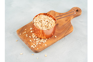 Rolled oats in measuring cup on, a Food & Drink Photo by Lifemorning