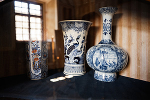 Elegant vintage ceramic vases with intricate blue and white decorative patterns, a Photo by AS photostudio