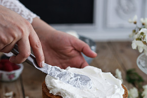 Woman frosting a cake