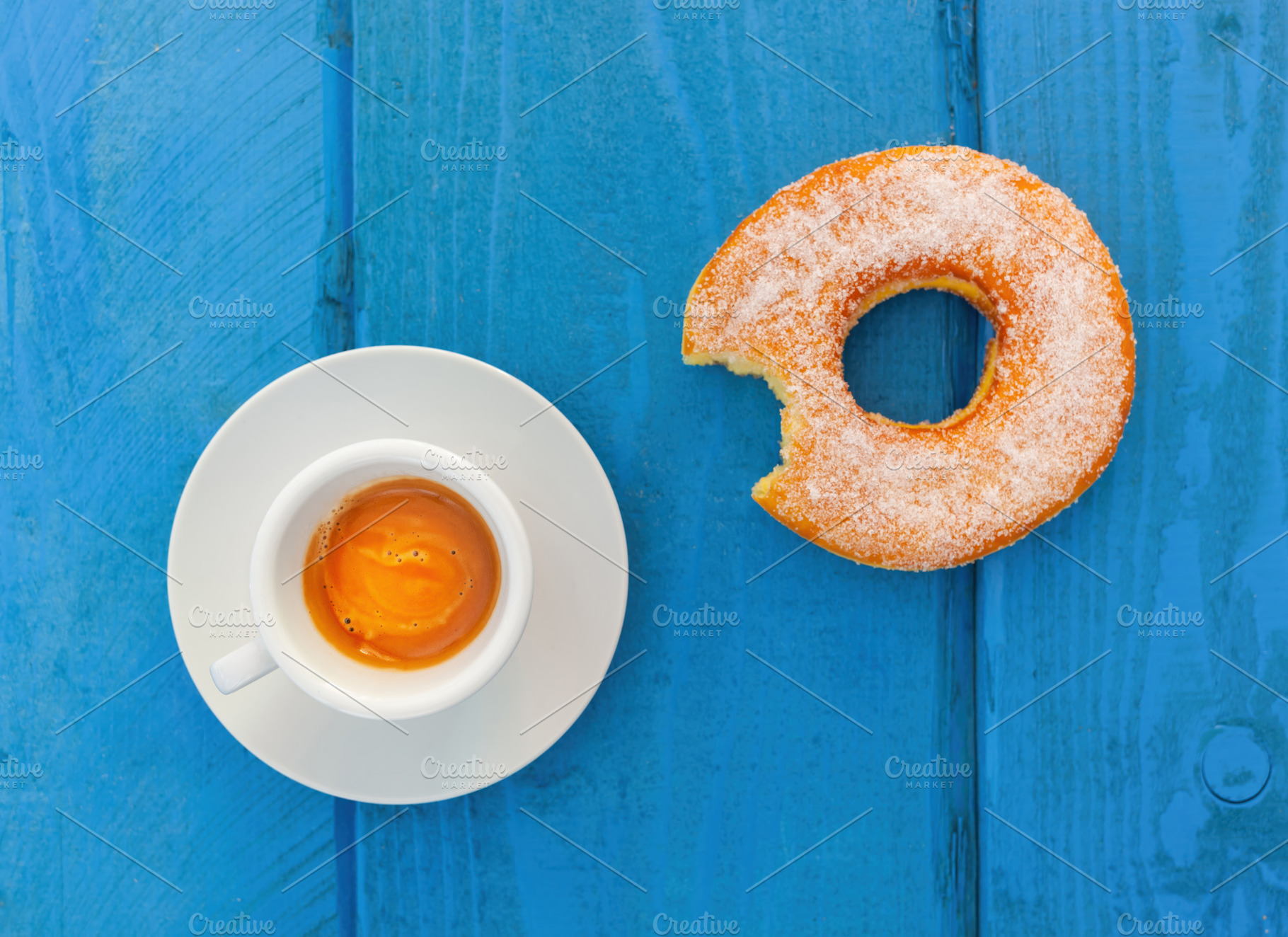 Sugary donut and espresso coffee resting on a blue wooden table for breakfast, a Food & Drink Photo by Antonio Gravante Market