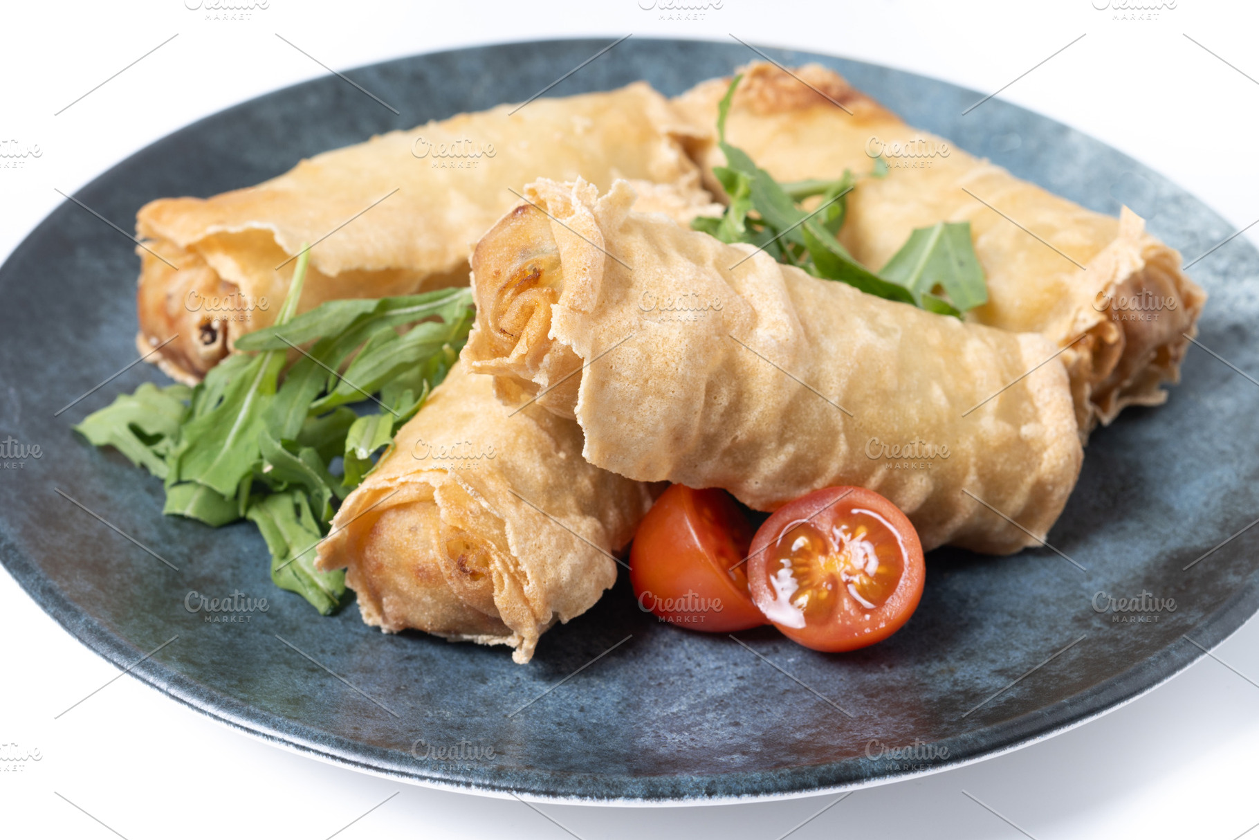 Crispy Spring Rolls on Ceramic Plate isolated on white background, a Food & Drink Photo by etorres69