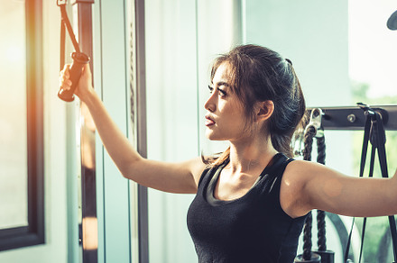 Asian young woman doing elastic rope exercises at cross fitness, a Sports & Recreation Photo by Ministocker