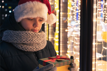 Boy in Santas hat with gifts box, a Person Photo by Jan Jack Russo Media