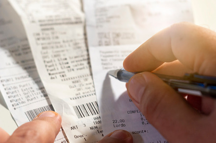 Checking a receipt featuring paper receipt, pen, and hand, a Business Photo by rarrarorro