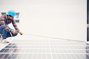 Solar panel installation, ruler or man measure photovoltaic cell, eco sustainability grid or renewable energy plate. Rooftop inspection, green power supply and male engineer check electricity cell, a Photo by Peopleimages.com