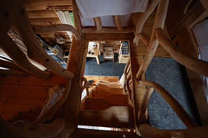 Rustic wooden staircase in cozy cabin with natural wood interior design element, a Photo by AS photostudio
