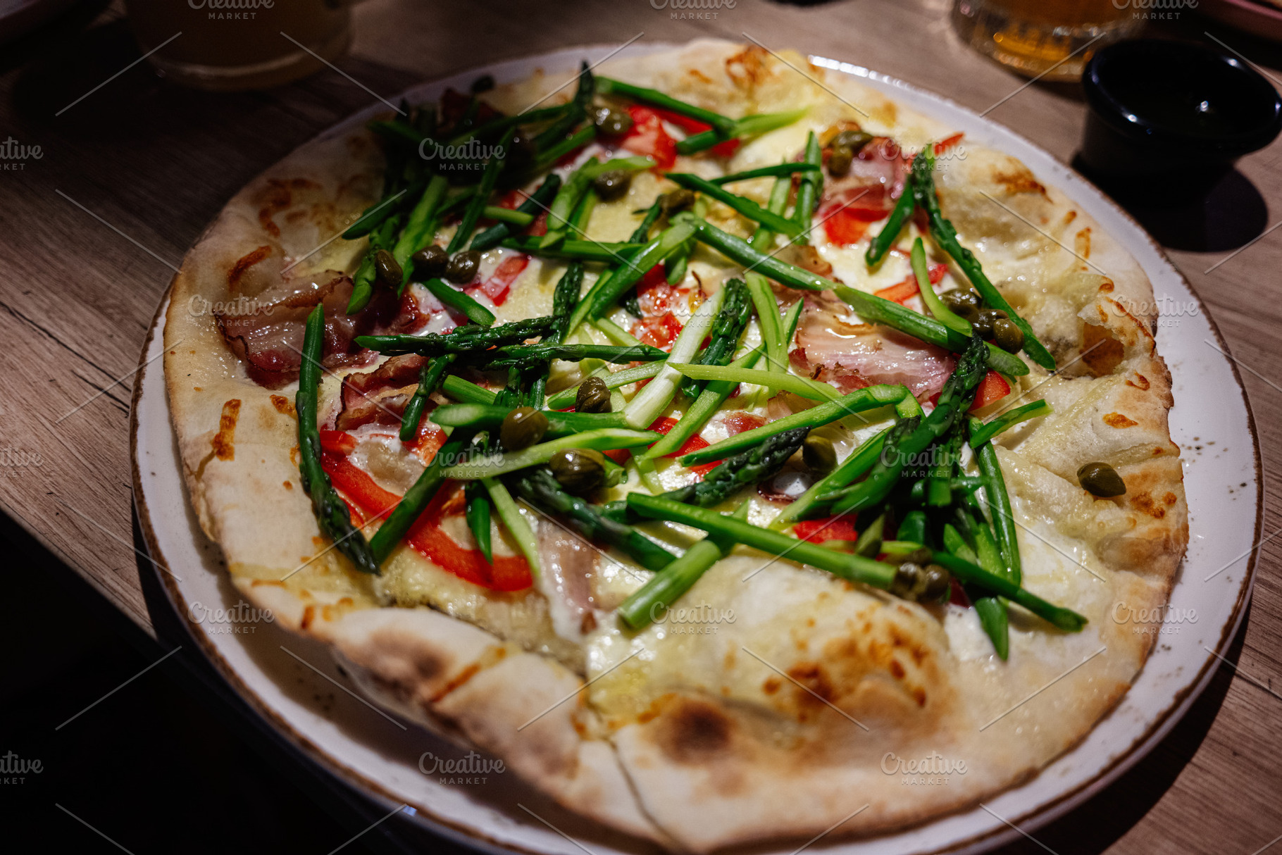 Delicious freshly prepared gourmet asparagus pizza topped with vibrant vegetabl, a Photo by AS photostudio