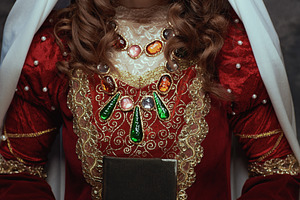 medieval queen in red dress with book and veil, a Person Photo by Alliance Images