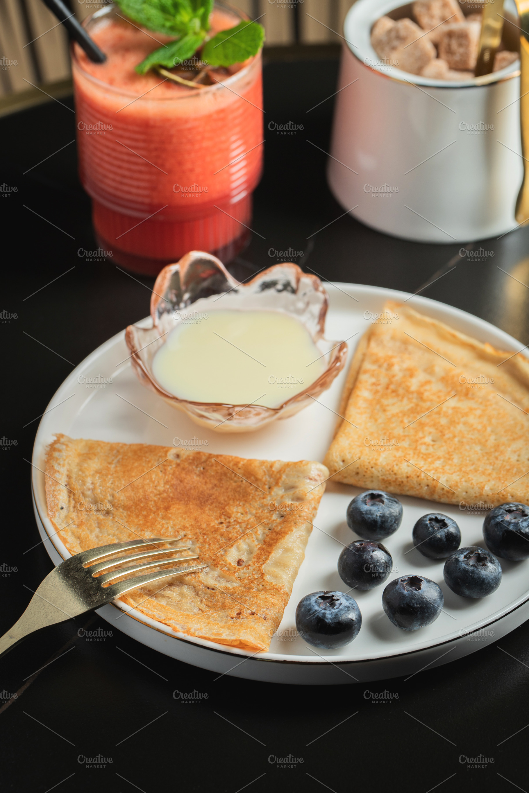 Pancakes with blueberry and honey on a white plate, a Food & Drink Photo by Budarinphoto