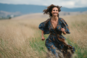 Woman runs joyfully through a field, a Photo by Beautiful things