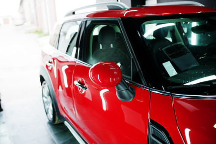 Red polished car in professional detailing garage., a Transportation Photo by AS photostudio