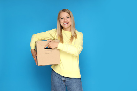 Concept of delivery, surprise, gift, young woman and cardboard b