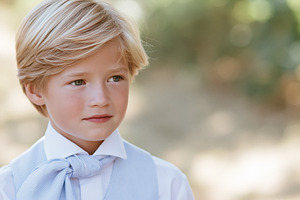 Young blonde boy in formal attire and a blue vest, portraying in, a Person Photo by Studio ANNA