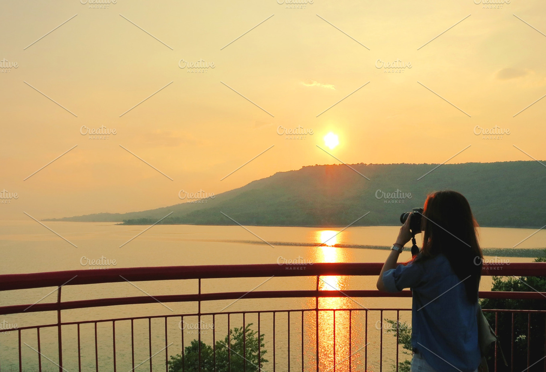 Beautiful sunset at a reservoir stock photo containing photographer and
