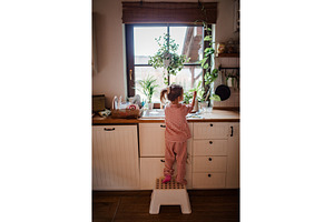 Independent child doing dishes at, a School & Education Photo by HalfPoint
