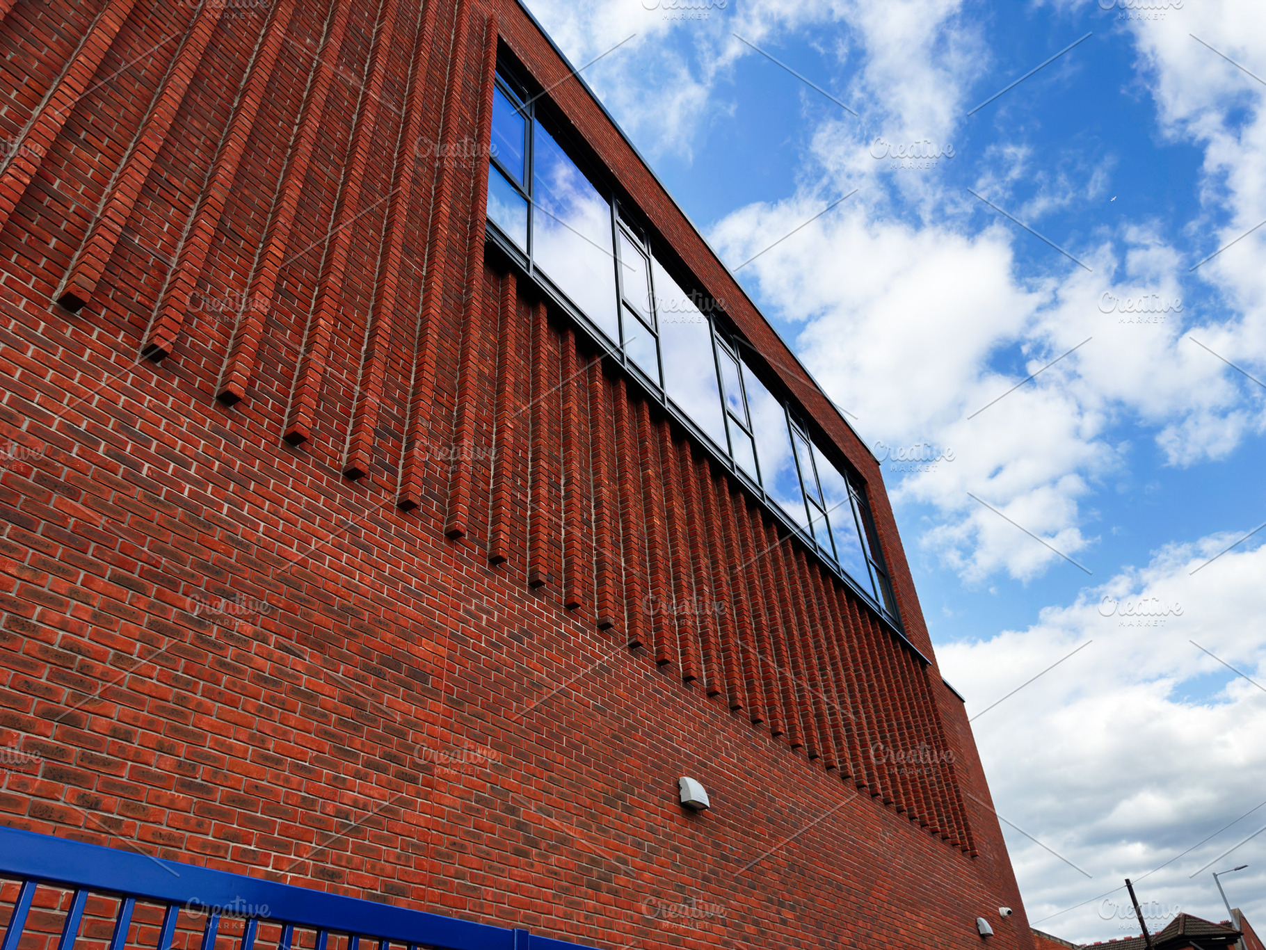Modern red brick building facade with reflective windows and bri, a Photo by AS photostudio