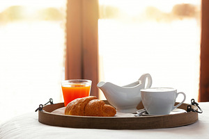 Delicious breakfast with cappuccino, croissant and orange juice served on a tra, a Food & Drink Photo by Antonio Gravante Market