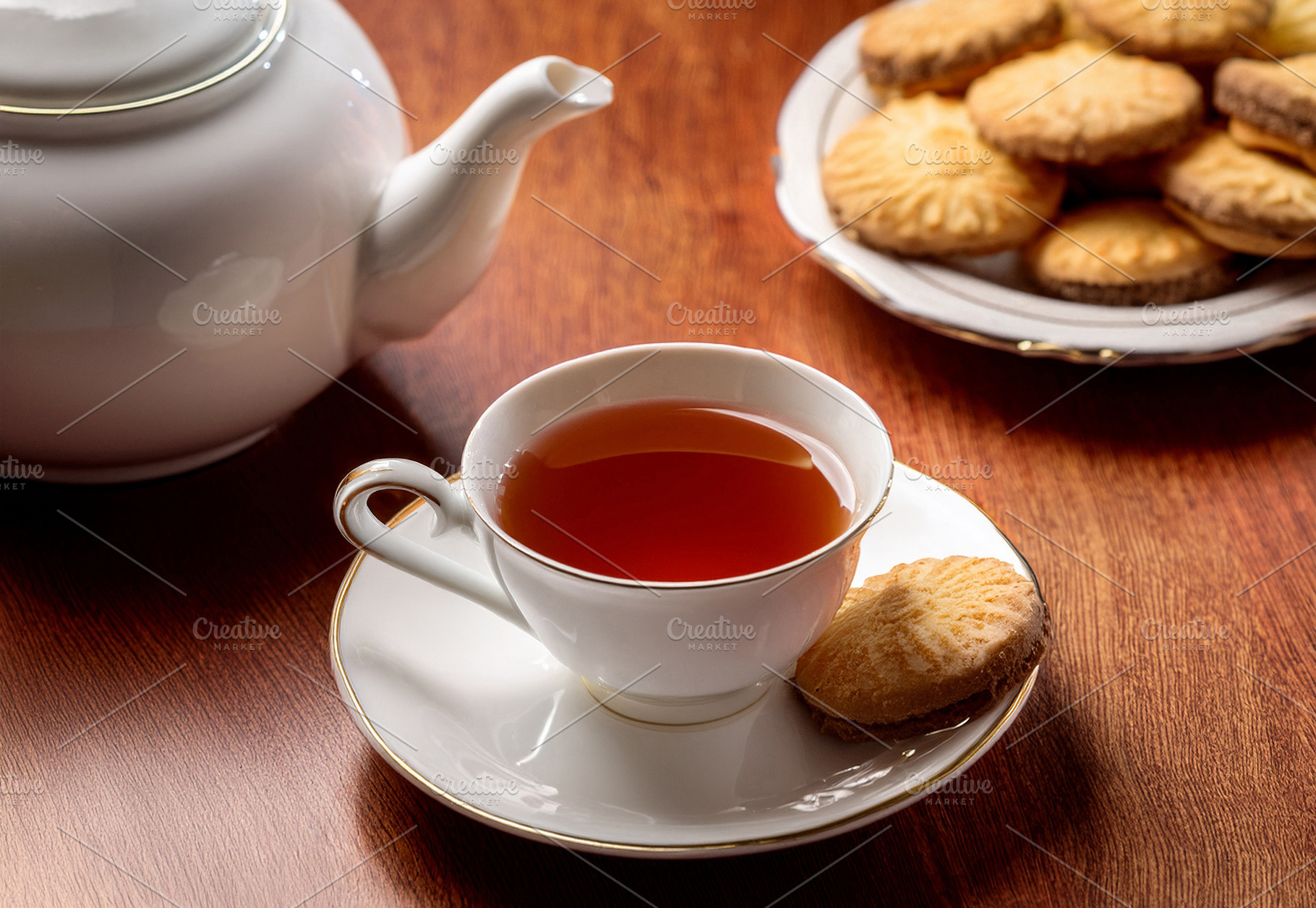 Black tea with cookies in classic white porcelain glassware, a Food & Drink Photo by Davizro's Market