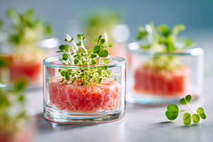 Tuna tartare with microgreens in glass containers, a Food & Drink Photo by AlyaAnd