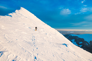 Mountaineer with dog climbing on mountain top, a Nature Photo by Vapi