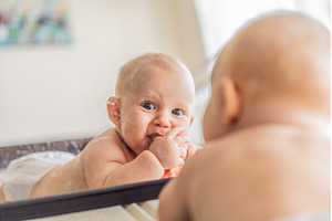 Baby lying on play mat learning to, a School & Education Photo by Elizaveta Galitskaya