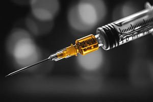 Syringe with liquid showcasing preci, a Photo by Tanuart