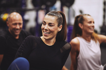 Laughing young woman relaxing after a gym class