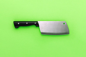 Stainless steel cleaver with black handle set against a vibrant, a Food & Drink Photo by Ales Munt