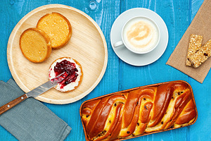 Continental breakfast with cappuccino, sweet braided bread, biscuits with jam a, a Food & Drink Photo by Antonio Gravante Market