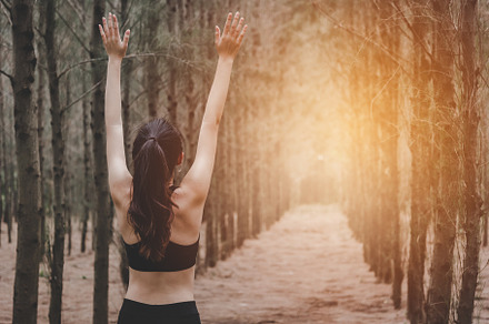 Asian young woman doing yoga and spreading arms in forest. Back, a Sports & Recreation Photo by Ministocker