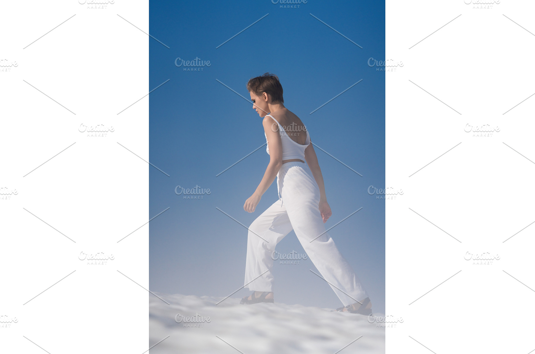 Slim blond woman walks through snow, a Beauty & Fashion Photo by Alexander-Piragis