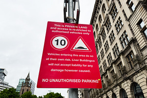 Red private land warning sign showing 10 speed limit and no unau