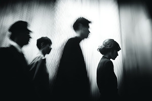 Employees walking in silhouette against a textured backdrop in a moody black an, a Photo by AS photostudio