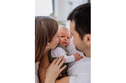 Happy parents cuddling with their, a Person Photo by HalfPoint