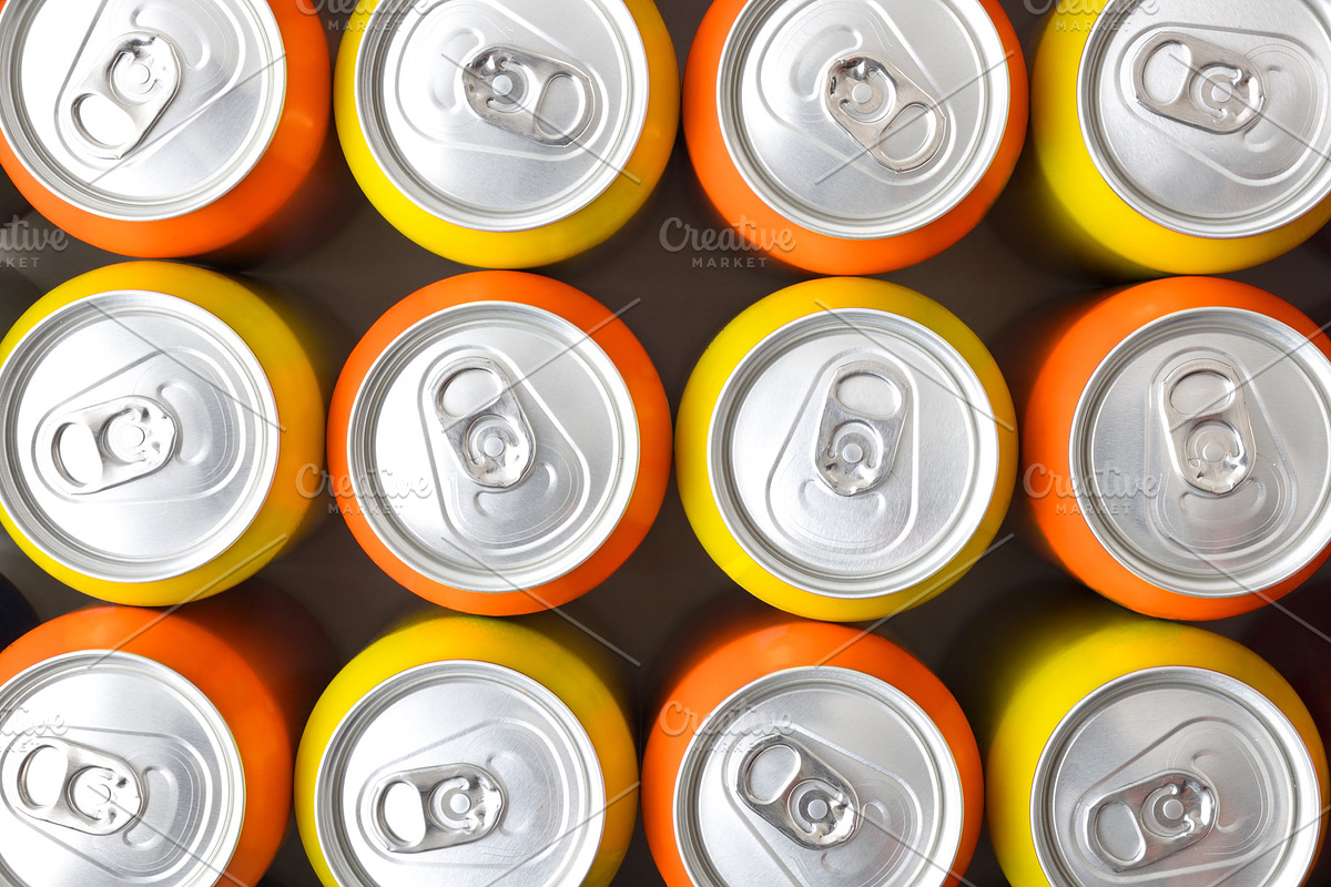Pattern of orange and yellow drink cans top view, a Food & Drink Photo by Davizro's Market (Photo 1 of 2)